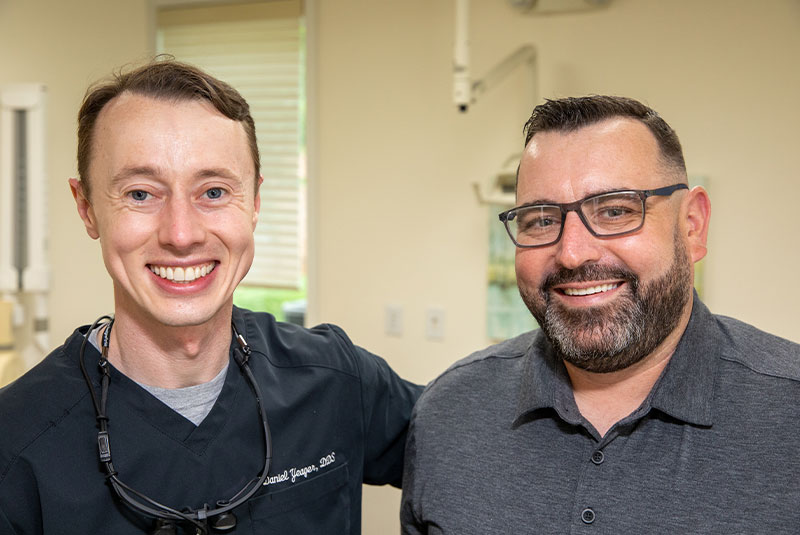 dentist smiling with dental implant patient